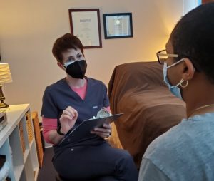 Patient and Provider speaking in a treatment room