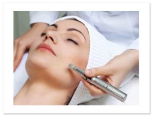 A woman receiving microneedling on the face